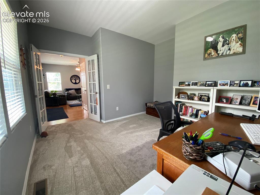 Image 14 of 40: The front room can function as a bedroom or home office, perfect for remote