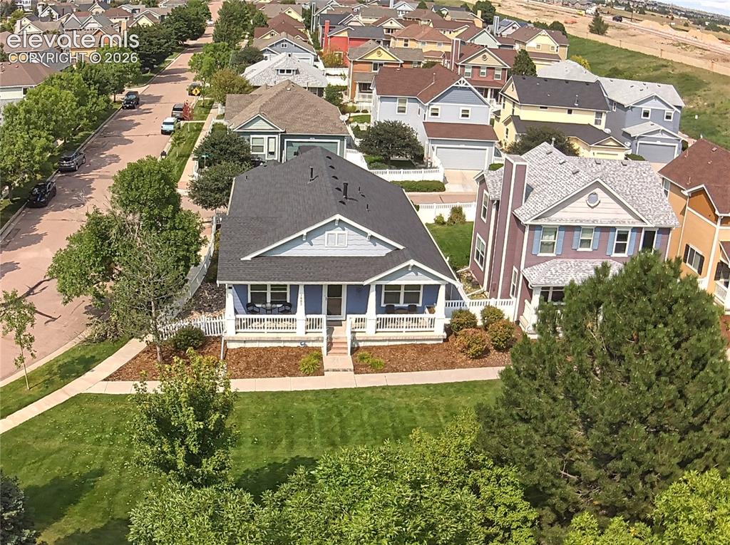 Image 33 of 40: The front common green area provides what feels like a bonus yard that is m
