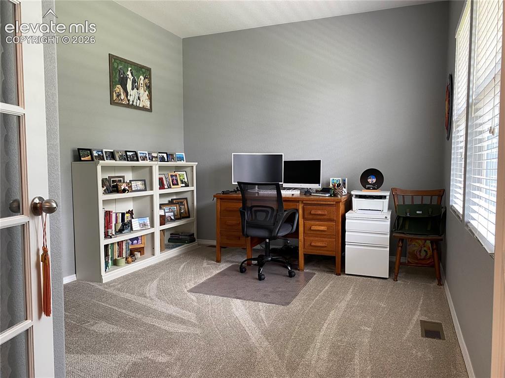 Image 4 of 40: This versatile front room can serve as a home office, bedroom or creative s