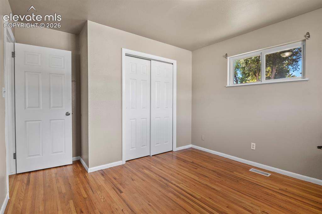 Image 16 of 26: 2nd bedroom with hardwood floor