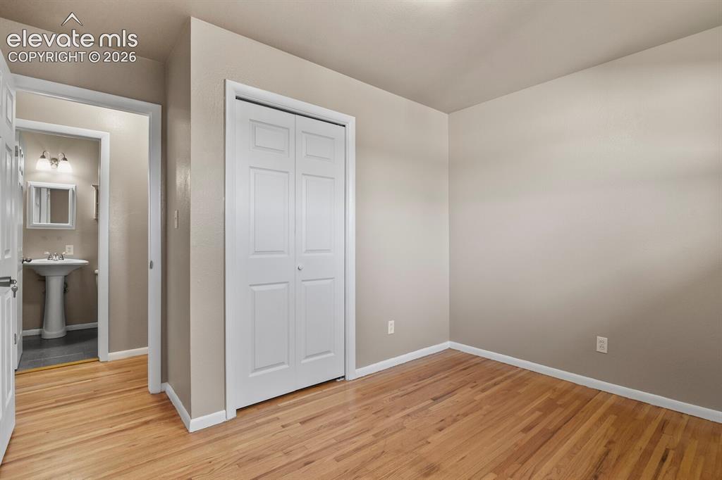 Image 19 of 26: 3rd bedroom with hardwood flooring