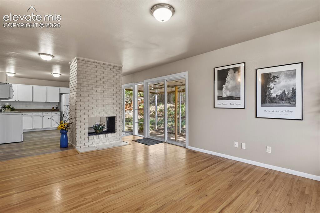 Image 7 of 26: with see thru fireplace to kitchen