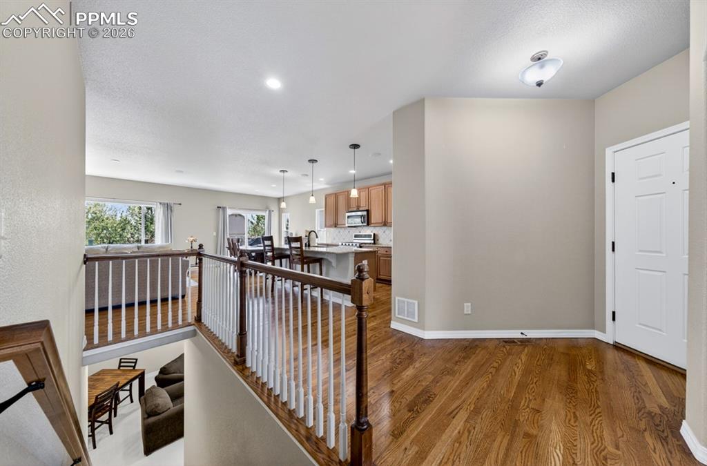 Image 17 of 47: View of front door to the right and looking down into the lower level