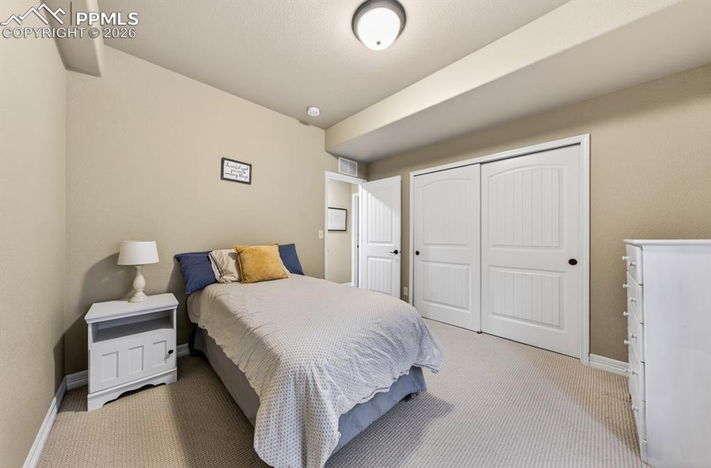 Image 29 of 47: Wall-to-wall carpeting with light neutral walls