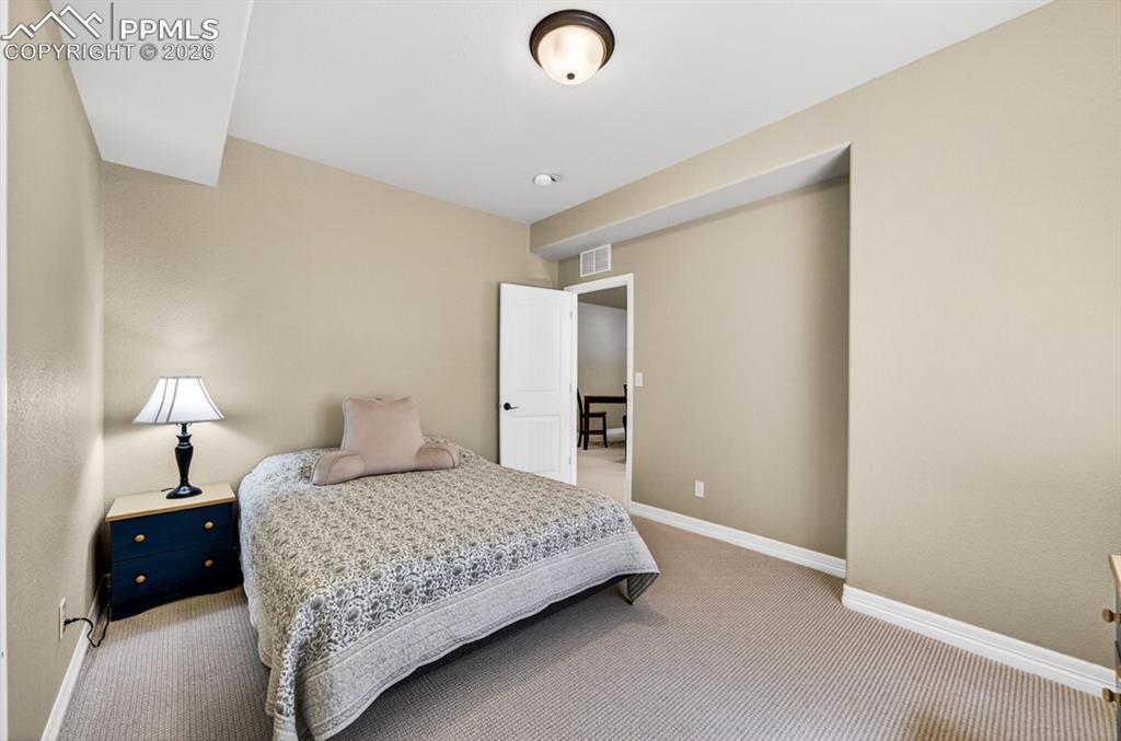 Image 33 of 47: Carpeted room featuring neutral wall tones, white trim, and a flush-mount c
