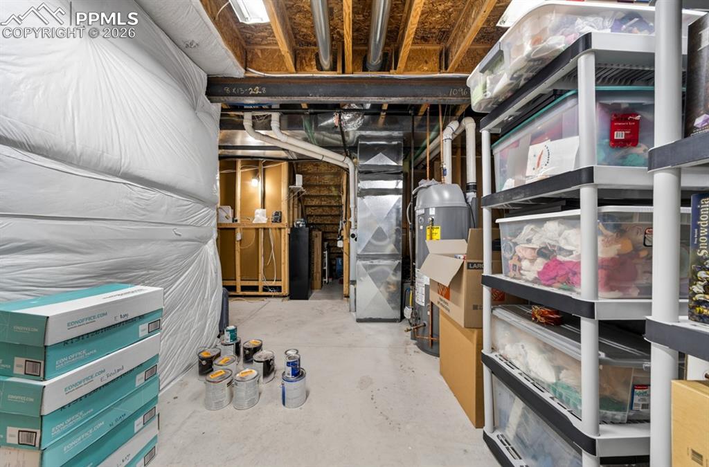 Image 37 of 47: Basement utility area with furnace and water heater