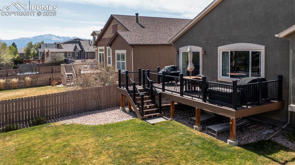 Image 38 of 47: Raised deck with composite decking and black metal railings