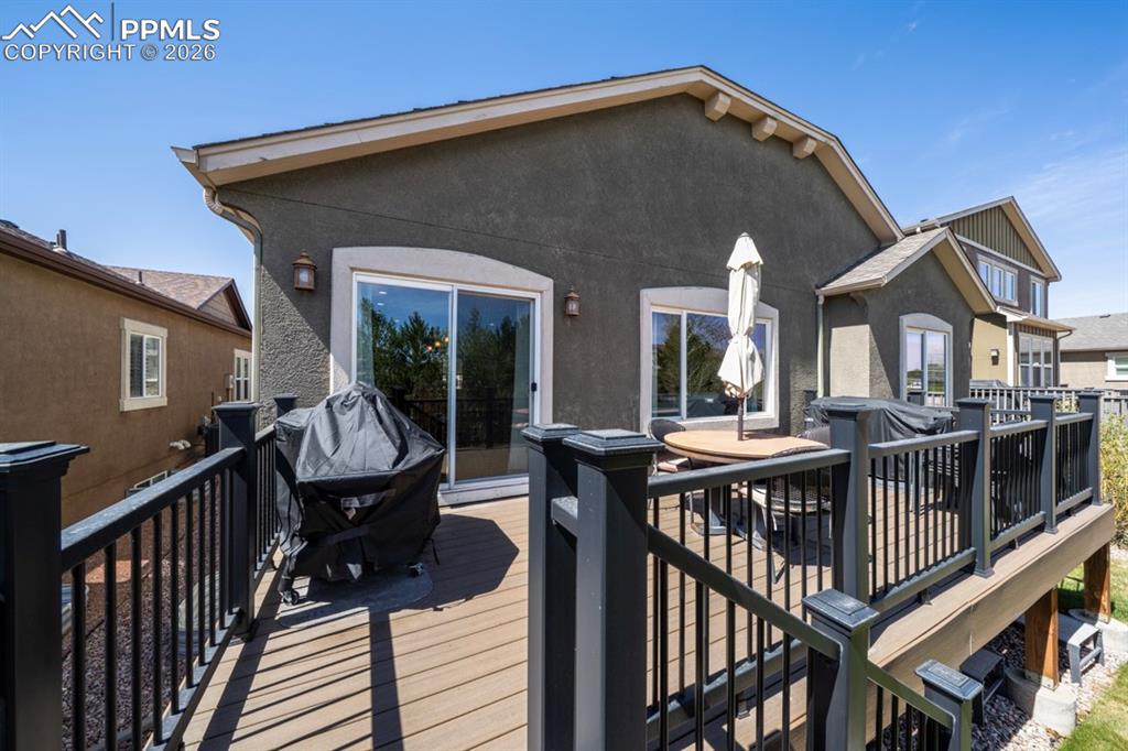 Image 39 of 47: Spacious elevated deck featuring composite decking and dark railings