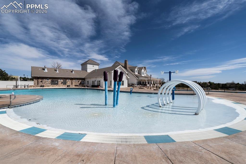 Image 45 of 47: Expansive aquatic area featuring multiple pools, a splash pad with water fe