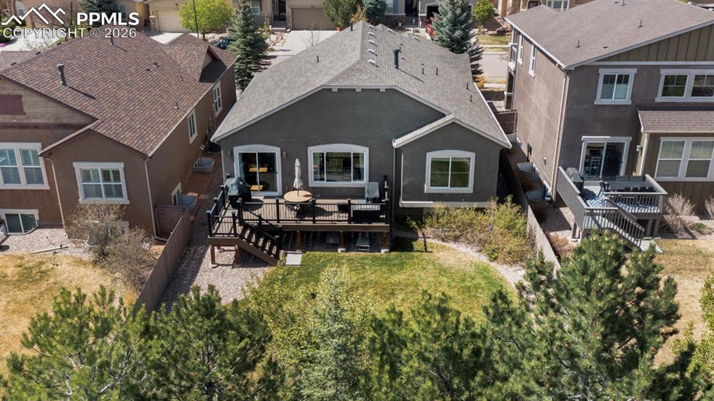 Image 5 of 47: Rear exterior featuring a multi-level composite deck, a sliding glass door,