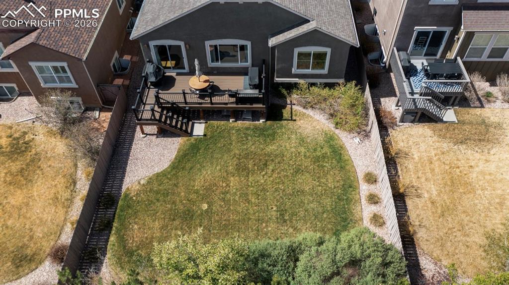 Image 6 of 47: Rear exterior featuring a multi-level deck, sliding glass doors, and a grou