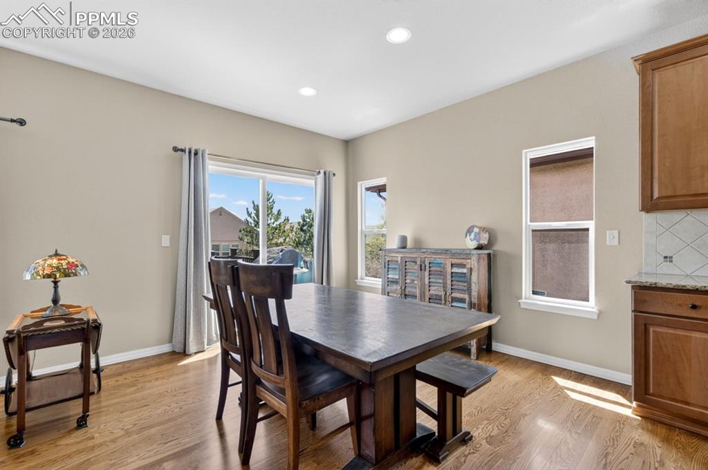 Image 9 of 47: Spacious dining area with recessed lighting, and a sliding glass door for o