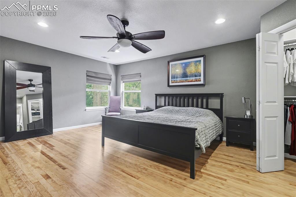 Image 17 of 44: Large, main level primary bedroom with newly finished wood floors