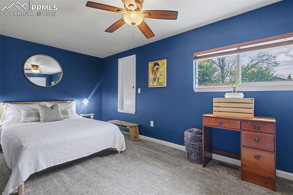 Image 23 of 44: Upstairs bedroom with access to the rooftop deck