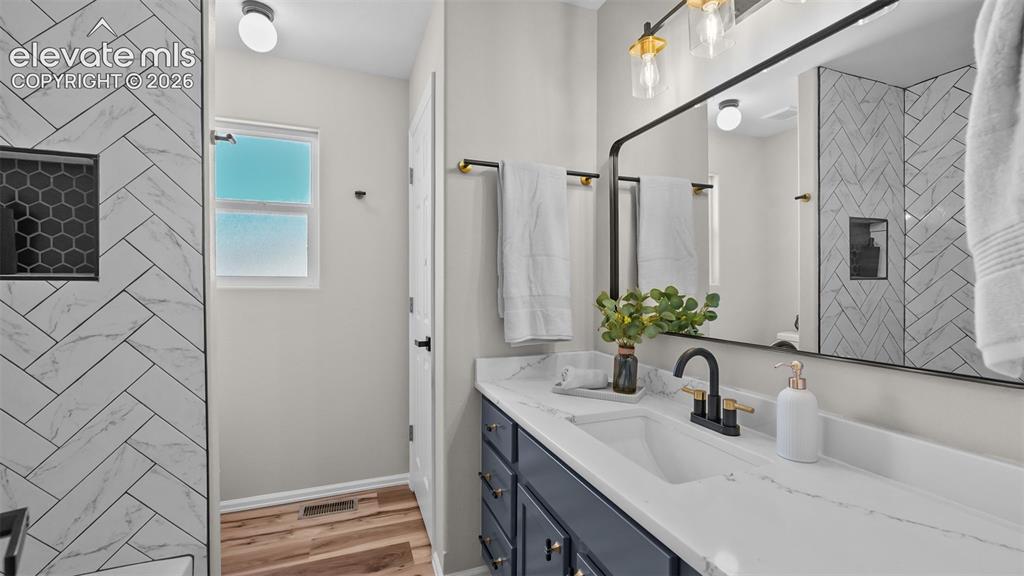 Image 18 of 47: White countertop with integrated sink and matte black faucet