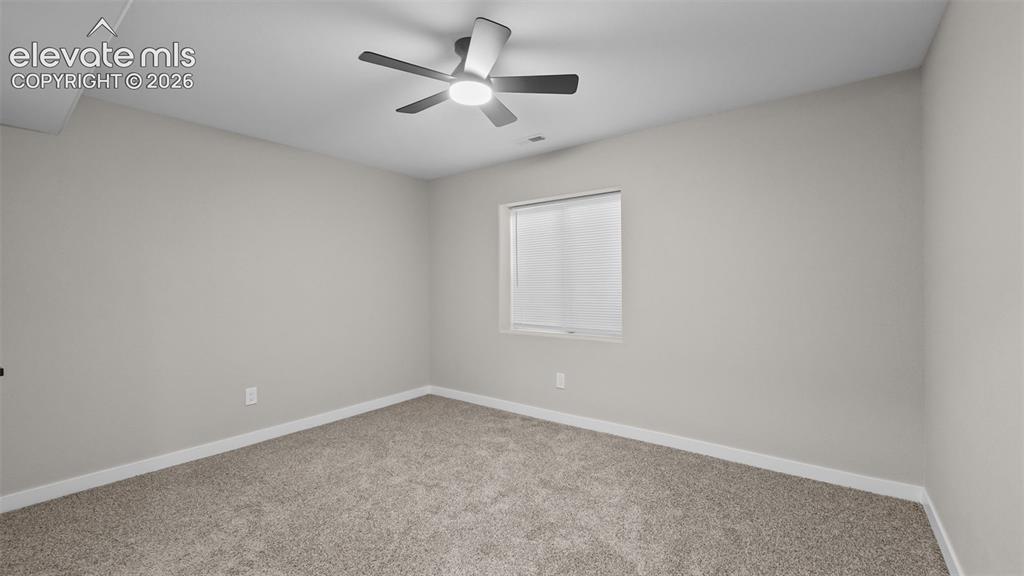 Image 29 of 47: Carpeted flooring, neutral wall finish, recessed window with blinds, and a
