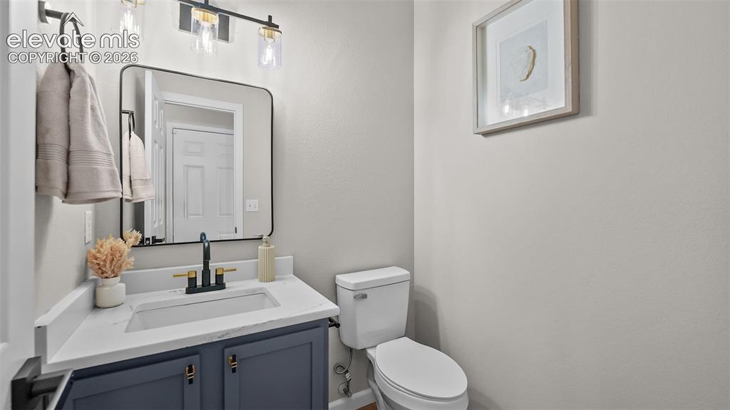 Image 8 of 47: Vanity with a white countertop and integrated sink, matte black and gold-to