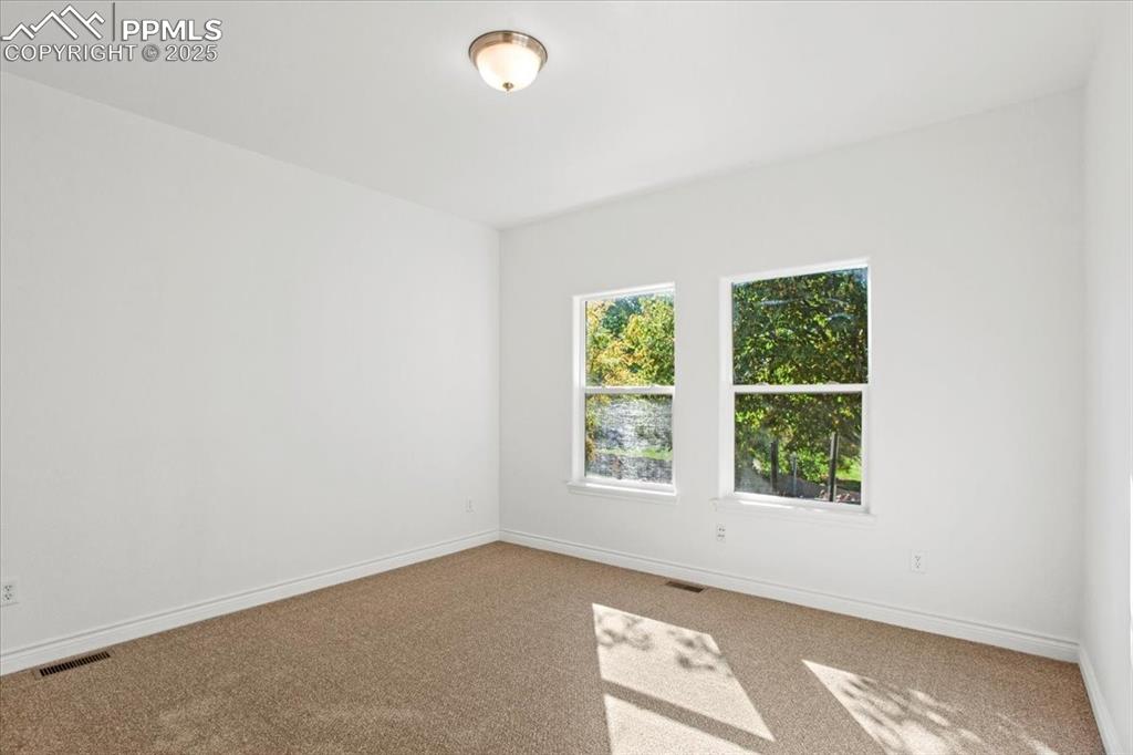 Image 12 of 31: Carpeted spare room with baseboards