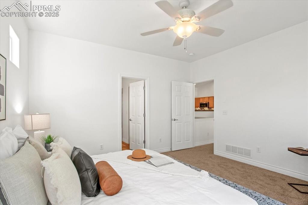Image 13 of 31: Bedroom with light carpet and ceiling fan