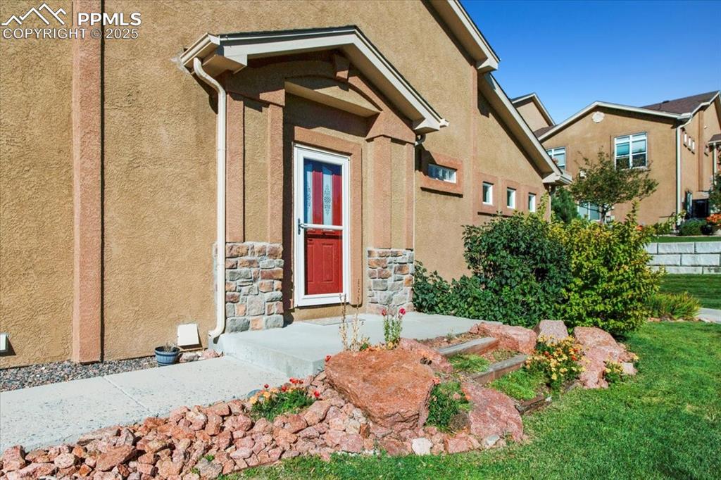 Image 26 of 31: Doorway to property with stucco siding