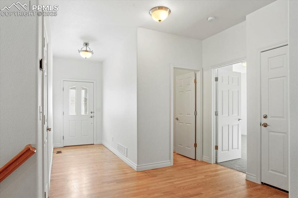 Image 5 of 31: Hallway featuring light wood finished floors and baseboards