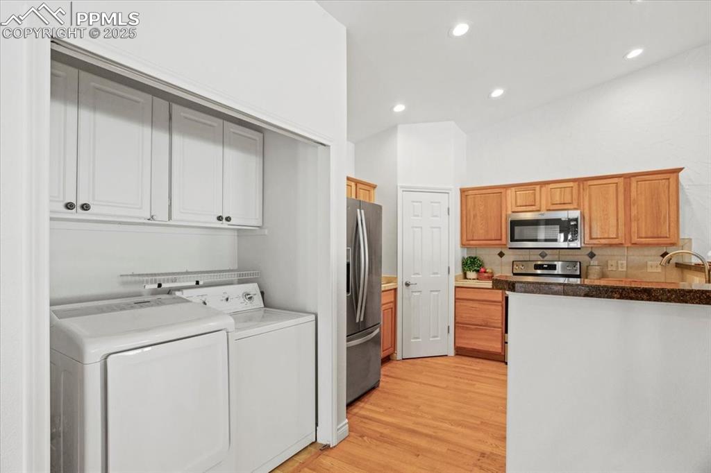 Image 8 of 31: Kitchen featuring recessed lighting, light wood finished floors, appliances
