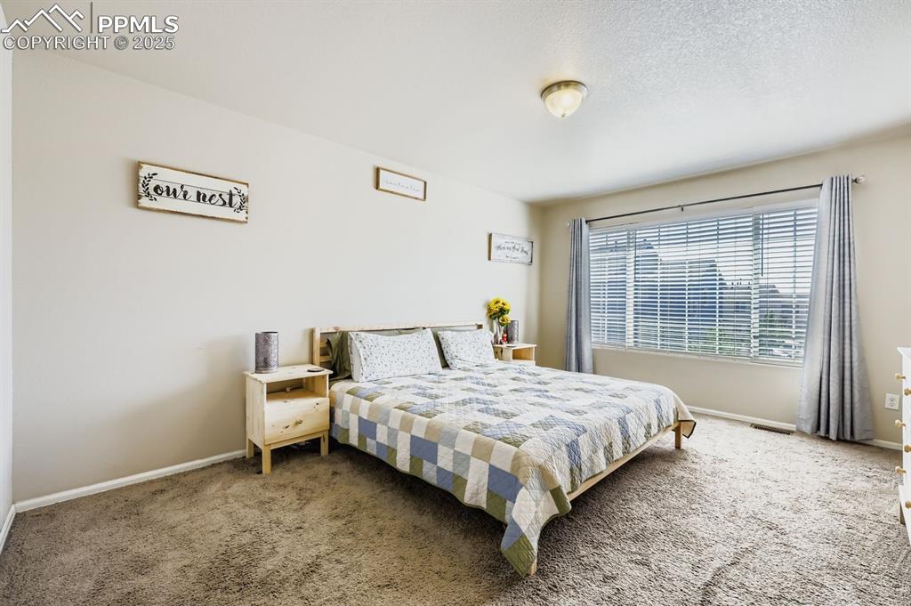 Image 15 of 27: Bedroom featuring carpet and baseboards