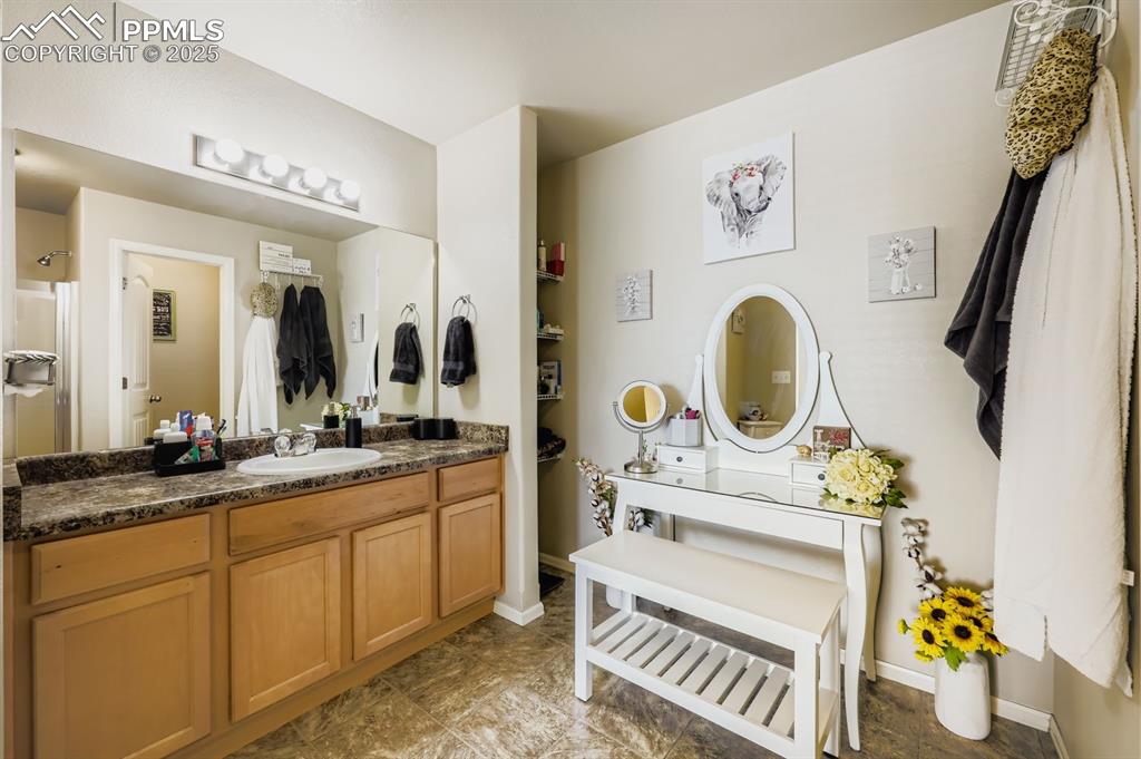 Image 17 of 27: Bathroom featuring vanity and baseboards