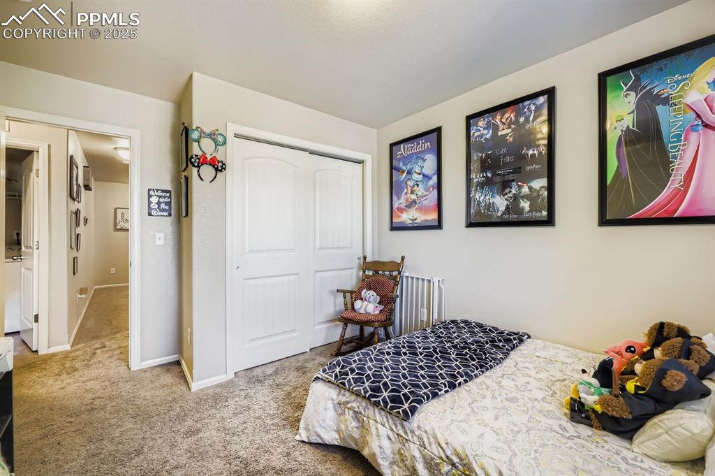 Image 21 of 27: Bedroom with a closet and light carpet