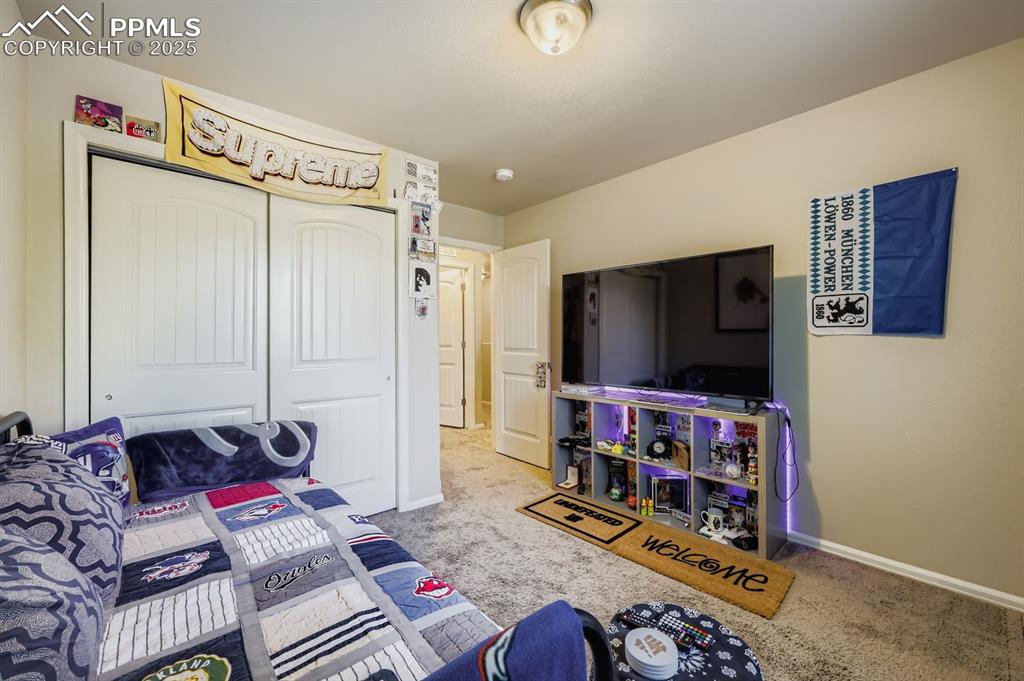 Image 23 of 27: Bedroom with carpet floors and a closet