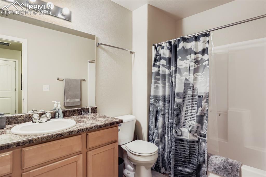 Image 24 of 27: Full bath with vanity and shower / bathtub combination with curtain