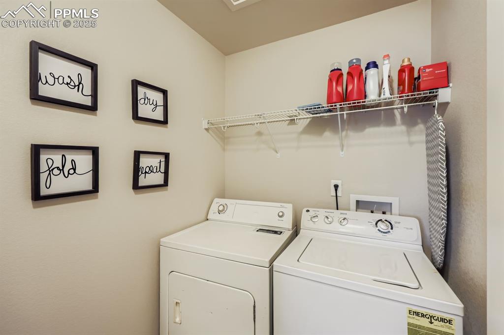 Image 26 of 27: Laundry room featuring separate washer and dryer