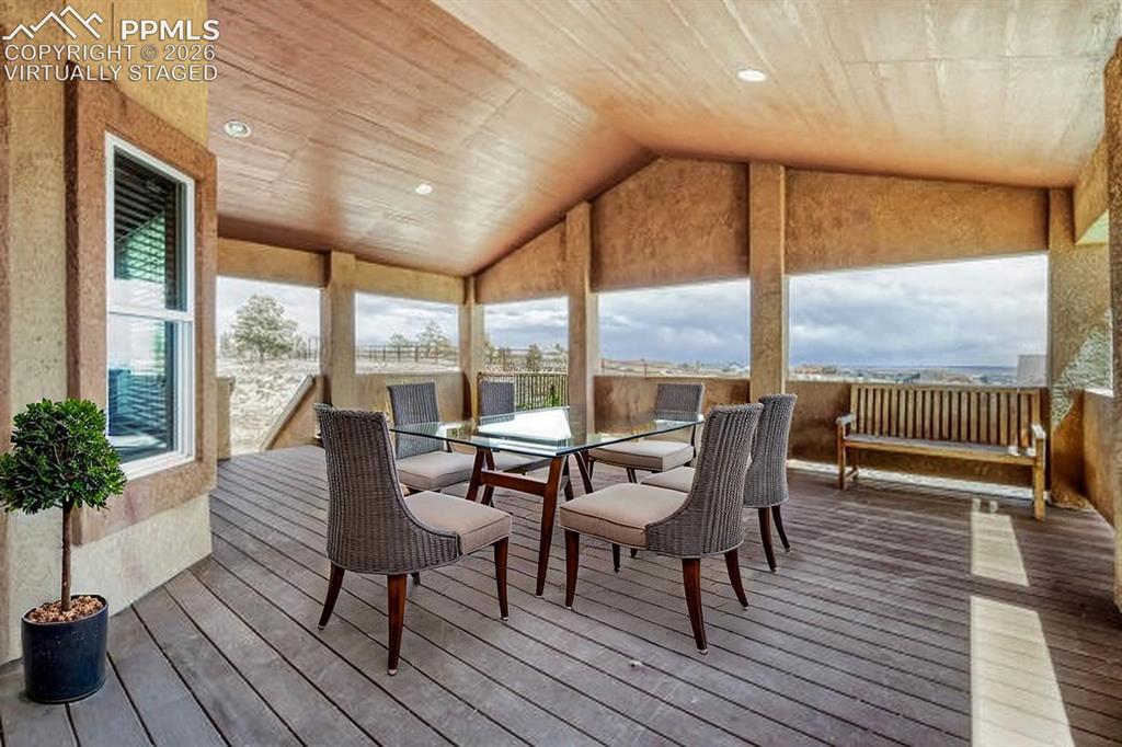 Image 13 of 31: Virtually Staged -Covered outdoor balcony featuring a wood-finish floor, re