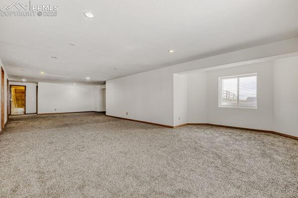 Image 22 of 31: Spacious lower-level room featuring light gray carpeting, recessed ceiling