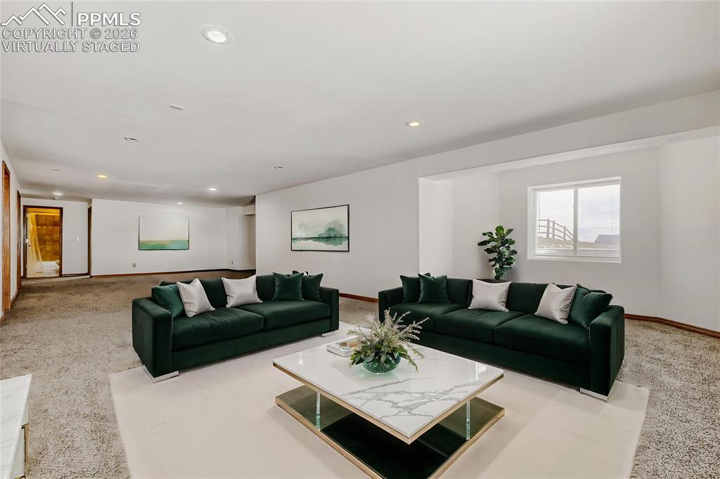 Image 23 of 31: Virtually Staged - Spacious room featuring neutral carpet flooring, recesse