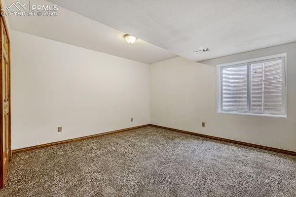 Image 25 of 31: Room featuring new neutral-toned carpeting, white painted walls, and wood t