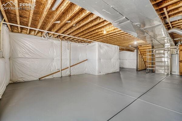 Image 26 of 31: Unfinished basement featuring a painted concrete floor, exposed wood ceilin
