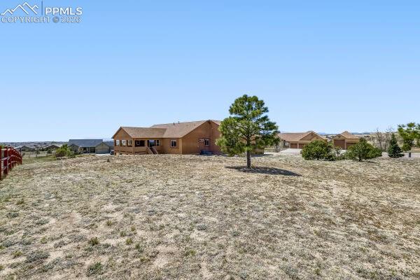 Image 27 of 31: Spacious property featuring a ranch-style residence with a covered porch, a