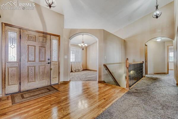 Image 4 of 31: Hardwood flooring entrance featuring a paneled front door with sidelight wi