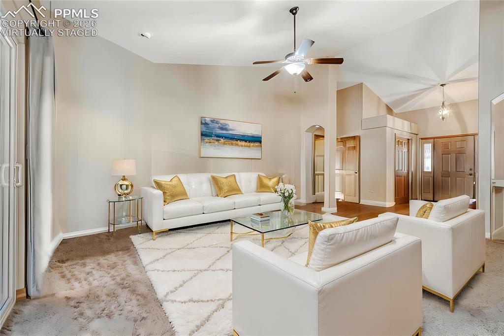 Image 6 of 31: Virtually Staged -Spacious living area featuring vaulted ceilings, a ceilin