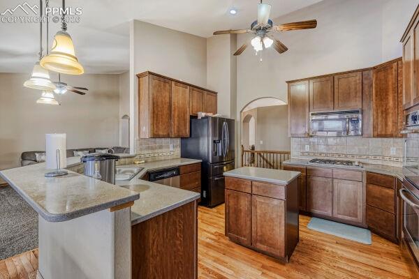 Image 7 of 31: Kitchen featuring wood-finish flooring, recessed lighting, and a vaulted ce