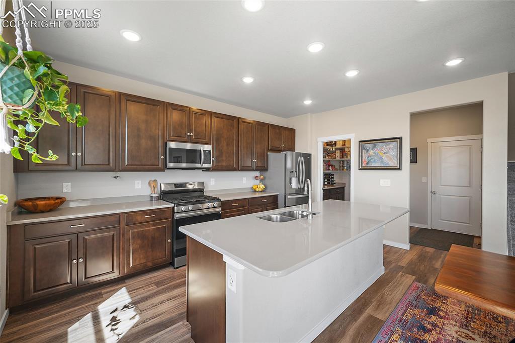 Image 12 of 40: Gourmet kitchen with oversized stone island