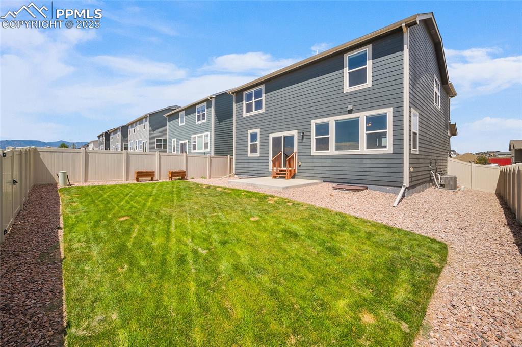 Image 33 of 40: Professionally landscaped backyard complete with sprinkler system