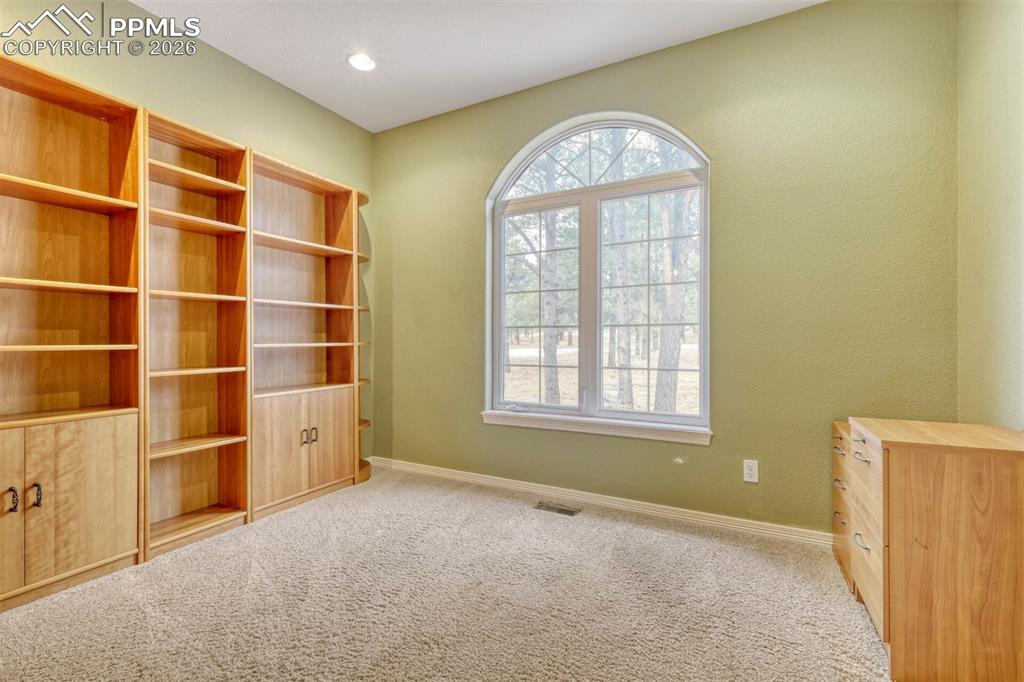 Image 13 of 50: Main Level office with bookshelves
