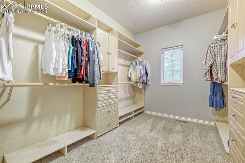 Image 18 of 50: Master closet with custom built in