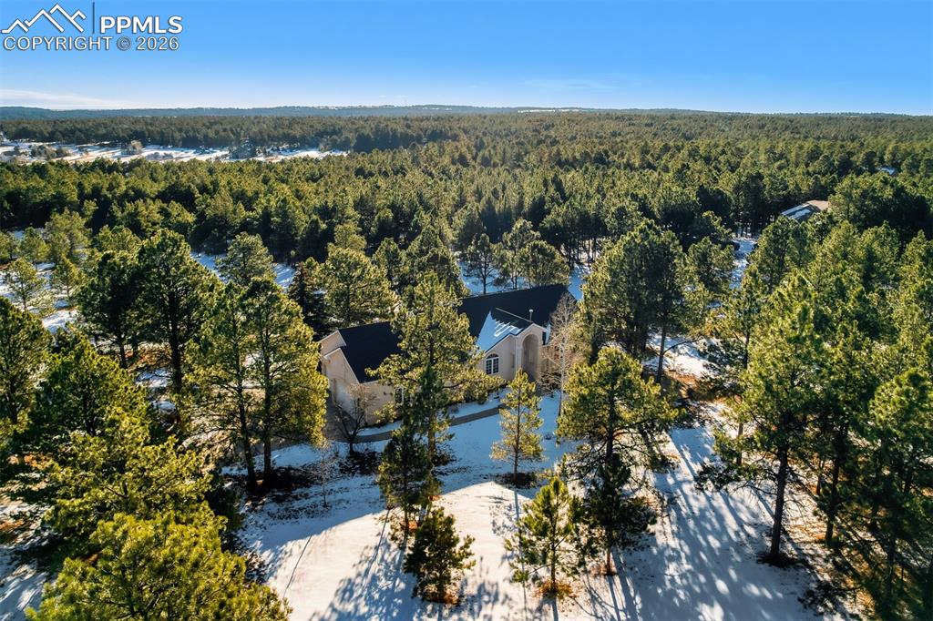 Image 44 of 50: View of subject property with a heavily wooded area