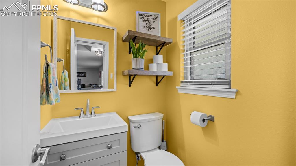 Image 12 of 44: Bathroom with toilet and vanity