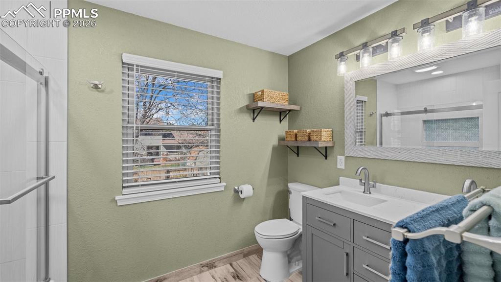 Image 18 of 44: Bathroom featuring a shower stall and vanity