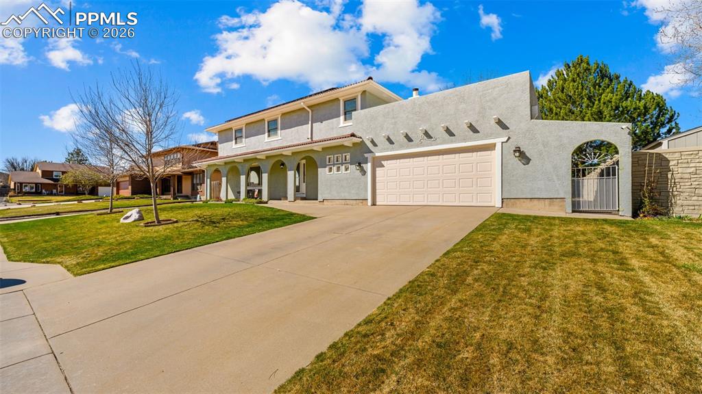 Image 2 of 44: Mediterranean / spanish-style house with a garage, stucco siding, concrete 