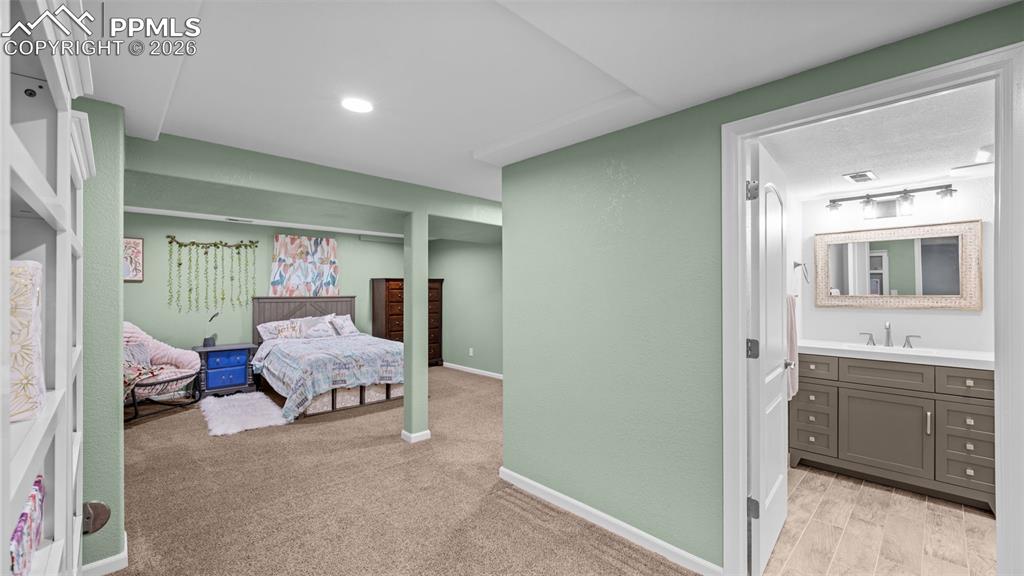 Image 24 of 44: Bedroom with ensuite bath and light carpet